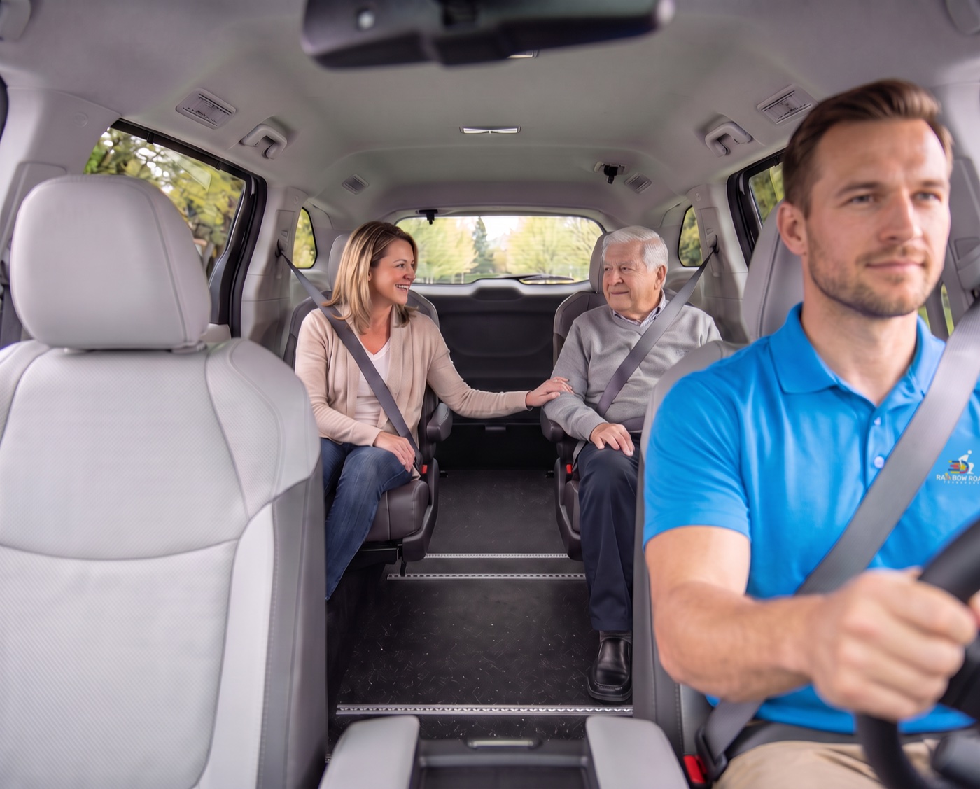 Inside a Rainbow Road Transport van: a client and a family member ride belted in the climate-controlled cabin while the Transportation Specialist drives